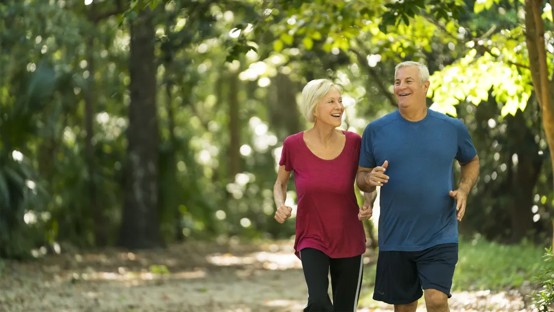 Older couple Jogging through the woods