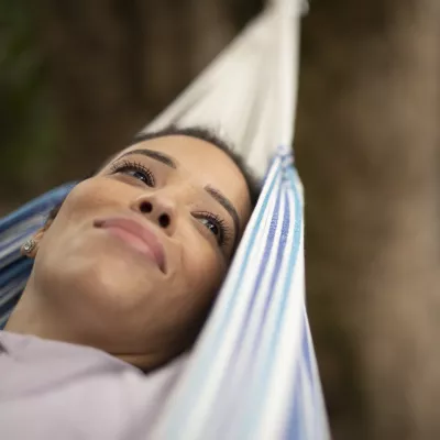 Woman relaxing in hammock outdoors