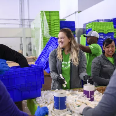 Volunteers sorting shampoo bottles