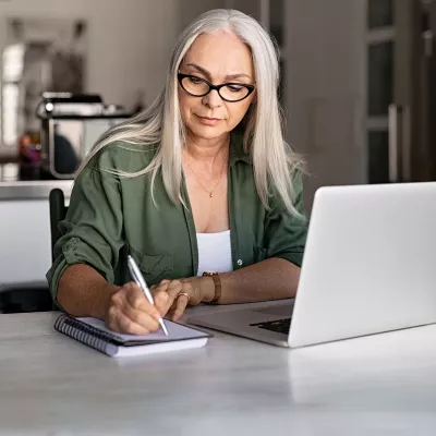 Woman with planner and laptop.