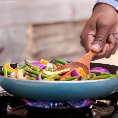 A man cooking a healthy meal at home.