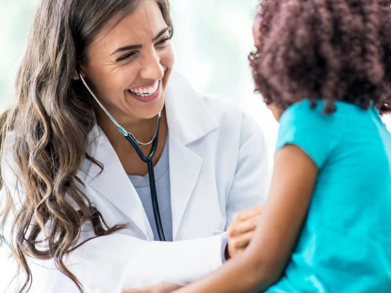 Doctor laughing with a young patient