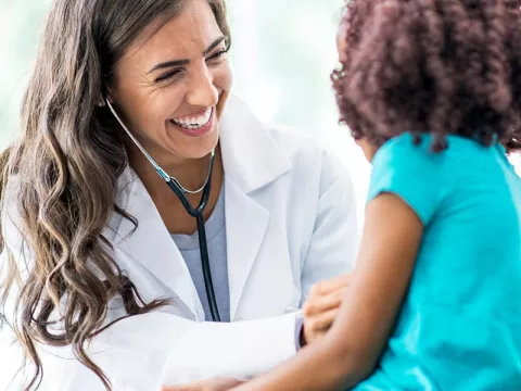 Doctor laughing with a young patient