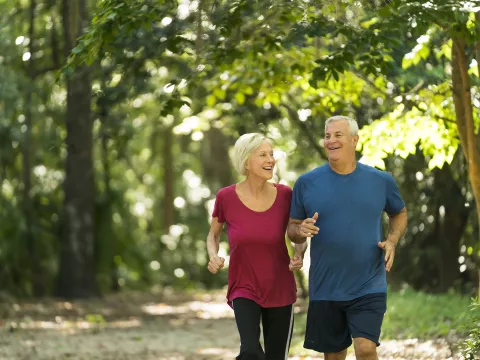 Older couple Jogging through the woods