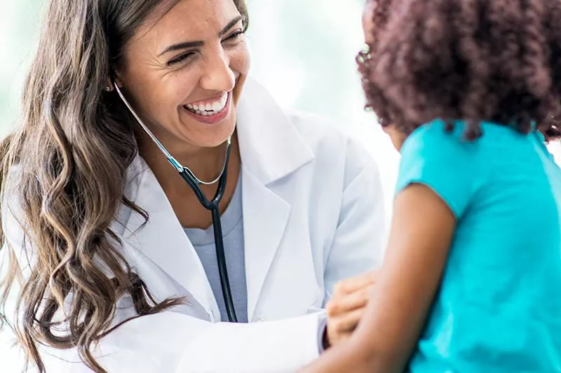 Doctor laughing with a young patient