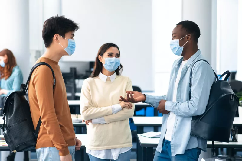 A group of students talking in their classroom
