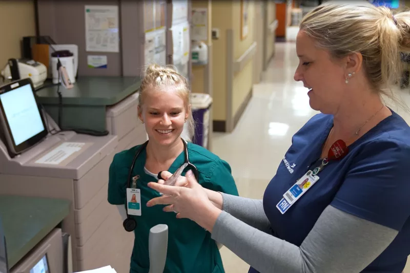 A preceptor nurse at AdventHealth Palm Coast mentors a student-nurse from Jacksonville University.