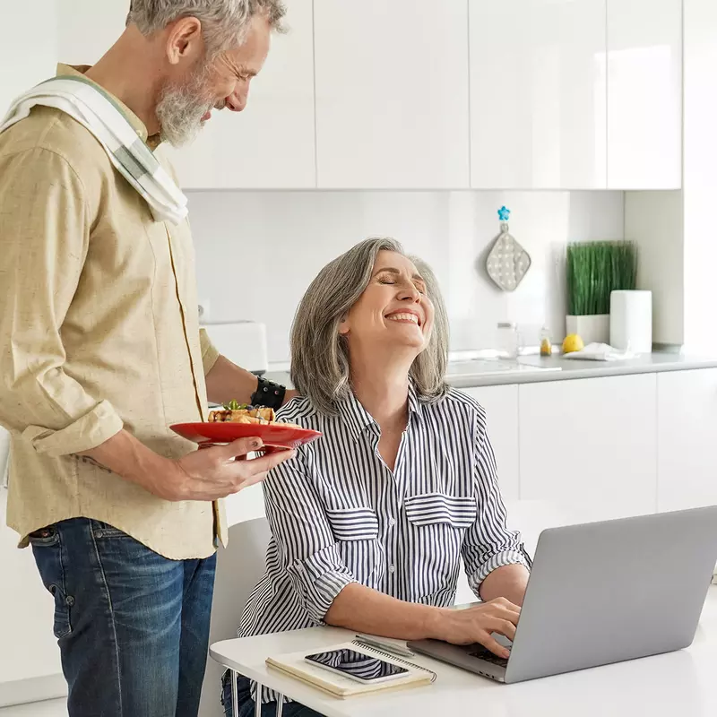 A couple having a content conversation in their kitchen