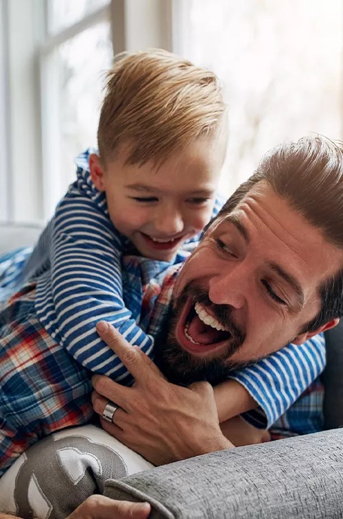 Son Hugging Father on Couch